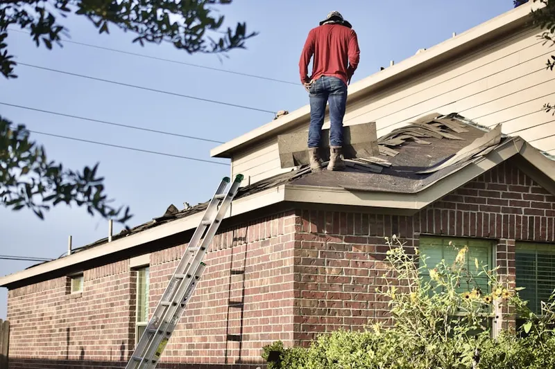 Professional roofer working on a residential roof in Bay Shores
